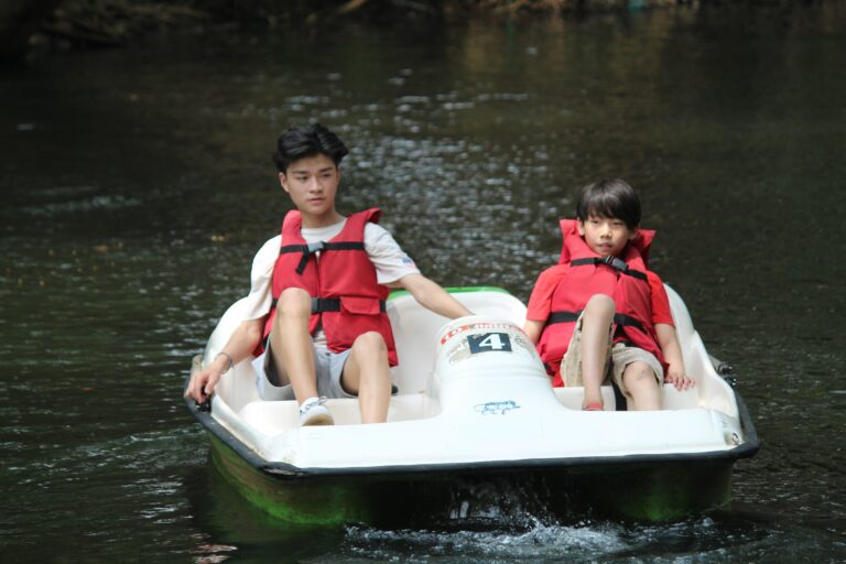 Two kids in a paddle boat