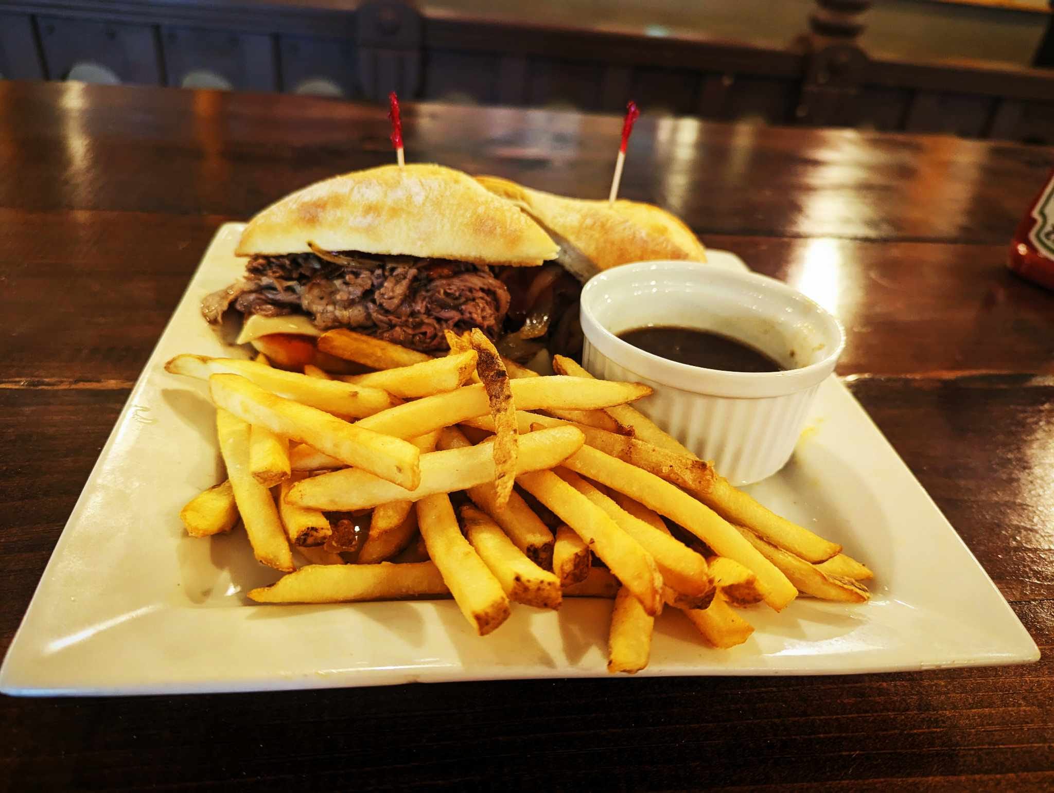 Sandwich and fries on a plate on a table