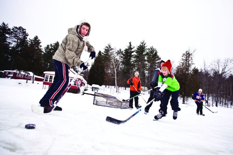 People playing Ice Hockey on a pond or lake