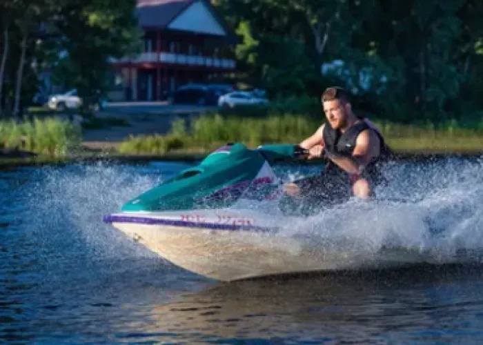 Man on Seadoo in front of Stoco Lake Lodge in Tweed, Ontario